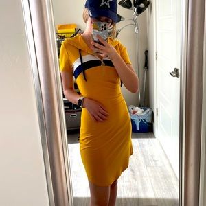 Form fitting yellow T-shirt dress with front zipper.